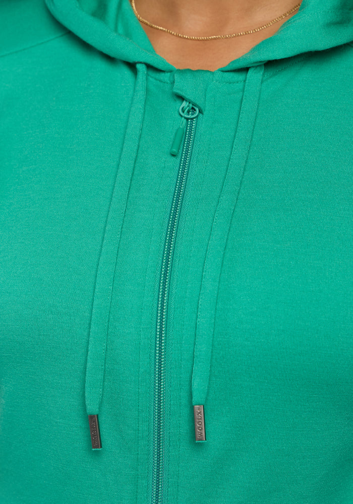 Close-up of the Woolx Ryann Hoodie - Jungle with drawstrings and a small gold necklace at the neckline.