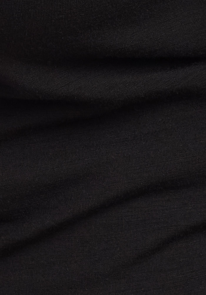 Close-up of the Woolx Sadie Baselayer Top in black, showing the Duralite merino fabric’s visible weave and soft folds—perfect for a heavyweight crew or merino wool base layer.