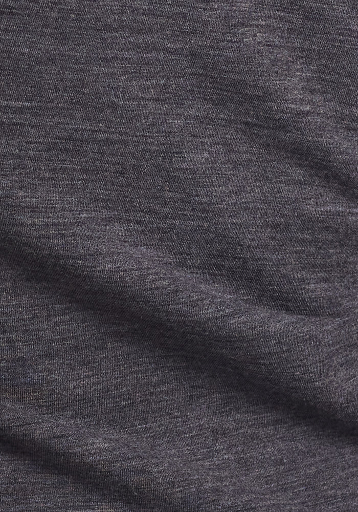 Close-up of Cinder Melange DuraLite fabric from Woolx's Stella Petite leggings, featuring a dark gray, slightly heathered texture with visible weave and gentle folds—ideal for soft Merino wool comfort.