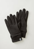 The Stone Harbor Gloves by Woolx, in black merino wool, feature a small logo tag on the left glove and are placed on a light grey background, making them perfect for winter activities.