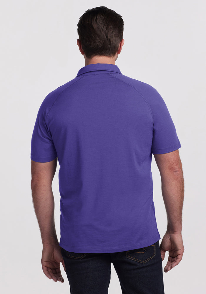 Man wearing the Woolx Summit Polo - Berry Indigo and dark jeans from the back—perfect for moisture-wicking style.