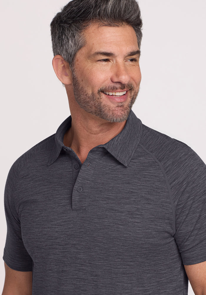 Smiling man with short dark hair and beard wears the Woolx Summit Polo • Final Sale - Cinder Melange.