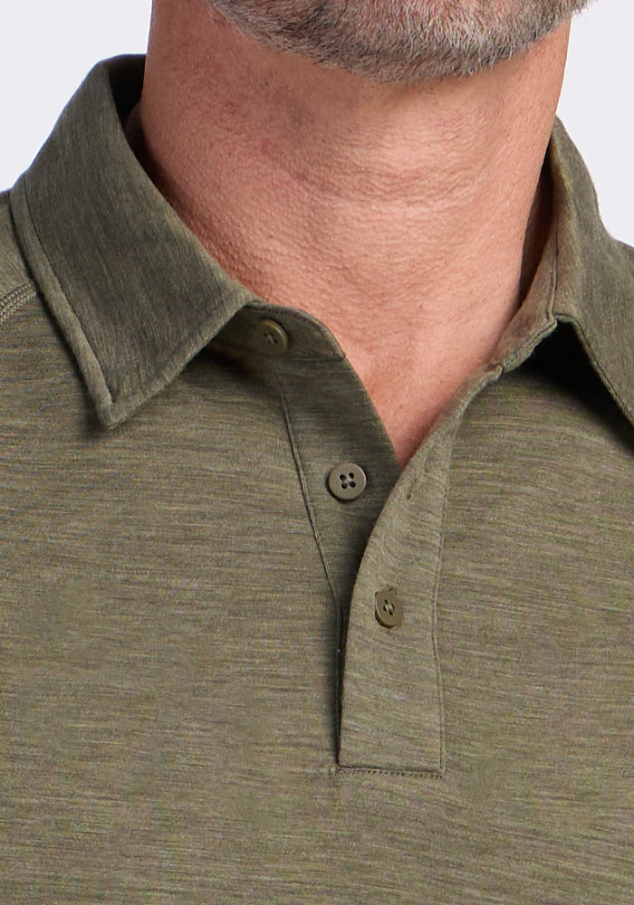 Close-up of a person wearing the Woolx Summit Polo in Sage Olive Melange, highlighting buttons and moisture management.