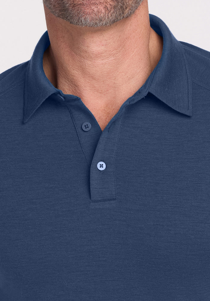 A man wearing the Woolx Summit Polo in Starry Night, shown from shoulders to chin.