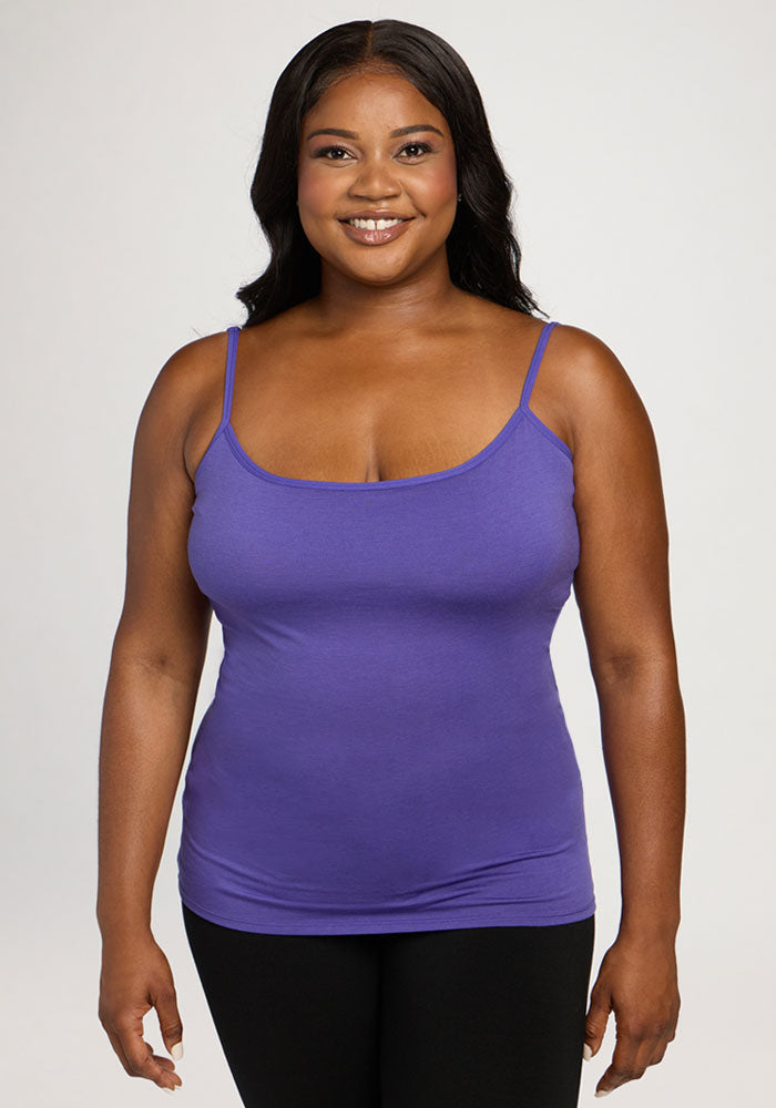 Woman in the Woolx Teagen Cami With Shelf Bra in Berry Indigo, smiling against a plain light background. | Sapphire is 5’8”, wearing a size XL