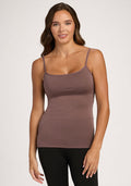 Woman with wavy brown hair in the Woolx Teagen Peppercorn cami with shelf bra and black pants, against a plain background. | Madeleine is 5’10”, wearing a size XS