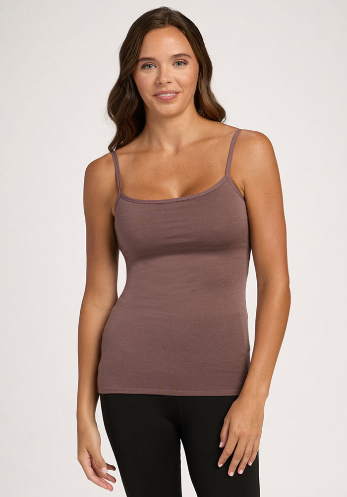 Woman with wavy brown hair in the Woolx Teagen Peppercorn cami with shelf bra and black pants, against a plain background. | Madeleine is 5’10”, wearing a size XS