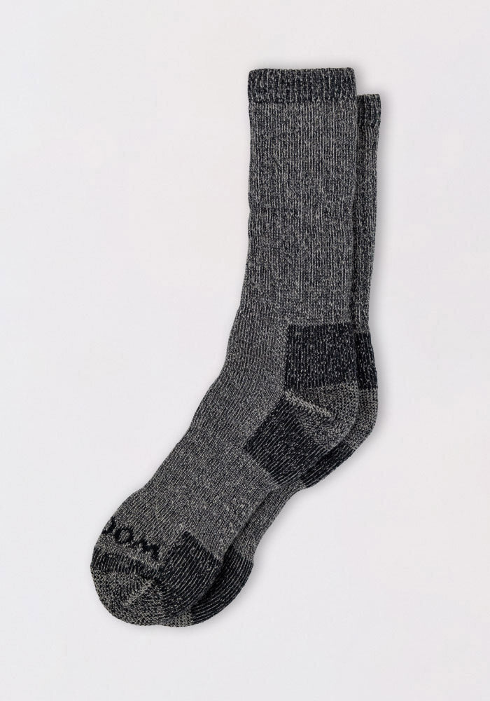 A pair of Woolx Womens Extreme Crew Socks in Charcoal Heather, featuring heavyweight merino wool and reinforced heels and toes—perfect for staying warm in cold weather.