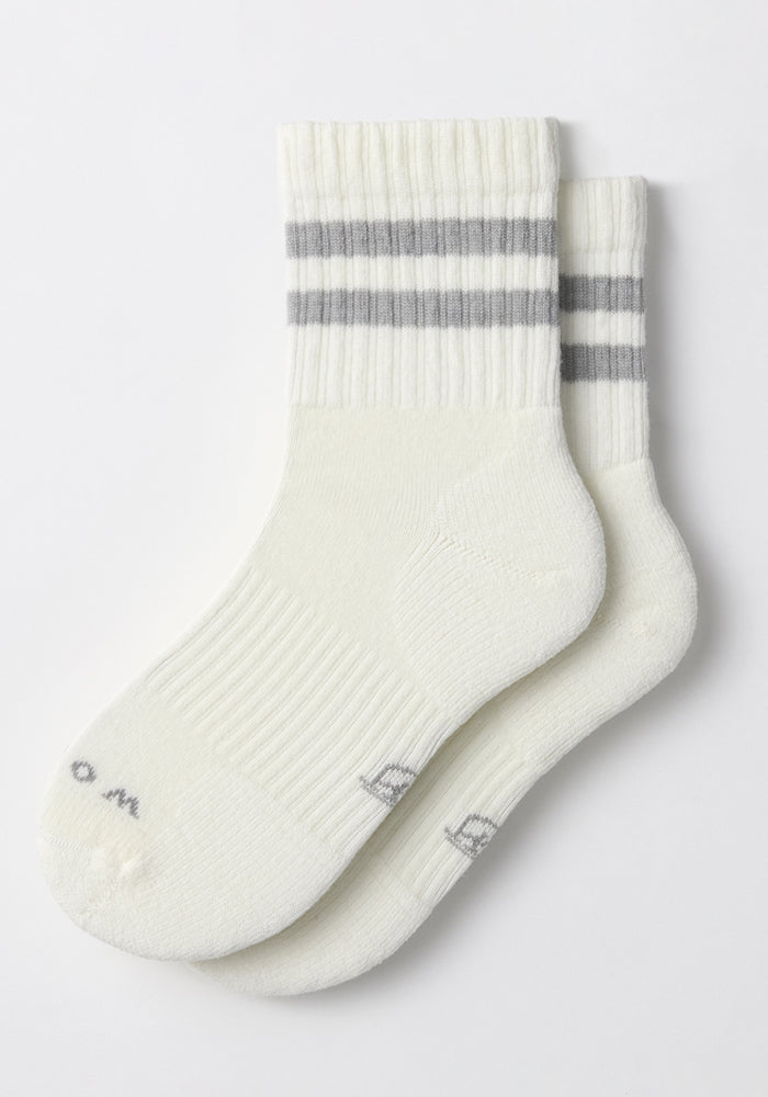The Womens Varsity Mini Crew Socks by Woolx in Polar White feature two gray stripes near the top, subtle gray toe lettering, and a moisture-wicking design to keep feet dry and comfortable.