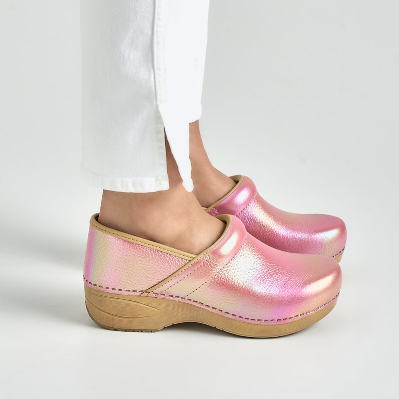 Close up of pink iridescent clogs with white backdrop.